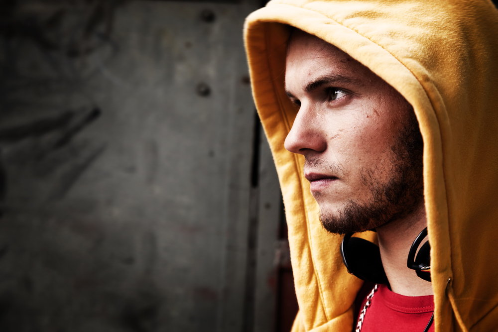 Profile of hooded Young man looking off